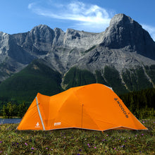 Load image into Gallery viewer, Side view of a fully built Woods Pinnacle Lightweight 4-Person 4-Season Tent overlooking the mountains