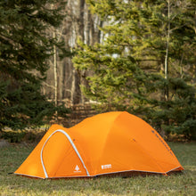 Load image into Gallery viewer, Side view of a fully built Woods Pinnacle Lightweight 4-Person 4-Season Tent on grassy campground