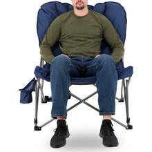 Load image into Gallery viewer, A man sitting on the Woods Mammoth Folding Padded Camping Chair in Navy