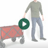 A person rolling the Woods Collapsible Utility King Wagon in Red