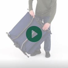 Load image into Gallery viewer, A man setting up the Woods Adjustable 2-in-1 Camping Lounger in Navy