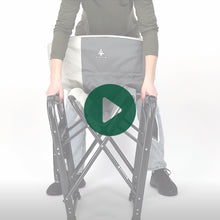 Load image into Gallery viewer, A person setting up the Woods Folding Directors Camping Chair with table in shade Gun Metal