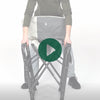 A person setting up the Woods Folding Directors Camping Chair with table in shade Gun Metal