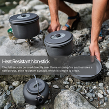 Load image into Gallery viewer, A person setting up the Woods Selkirk Anodized 4-piece Camping Cook Set on campground