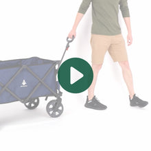 Load image into Gallery viewer, A person rolling the Woods Outdoor Collapsible Utility King Wagon in Navy