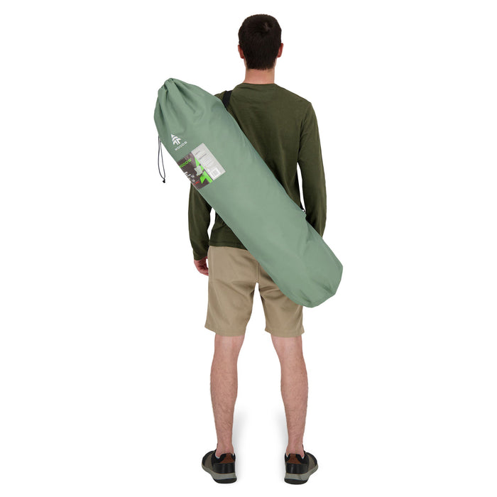 Behind view of a person carrying the Woods Mammoth Folding Padded Camping Chair in Sea Spray inside carry bag across their back