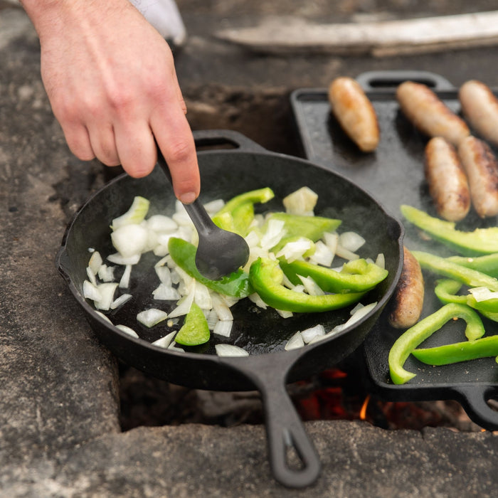 Close up of vegetables and sausages being cooked on the Woods Heritage skillet and griddle 