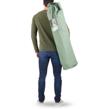 Load image into Gallery viewer, A person carrying the Woods Ashcroft 3-Position Camping Lounger Chair in Sea Spray across their back