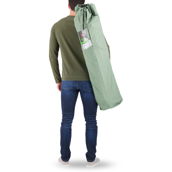 A person carrying the Woods Ashcroft 3-Position Camping Lounger Chair in Sea Spray across their back