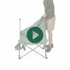 A person setting up the Woods Mammoth Folding Padded Camping Chair in Sea Spray