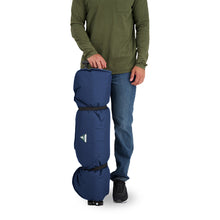 Load image into Gallery viewer, A person standing next to a rolled up Woods Mammoth Folding Padded Camping Chair in Navy