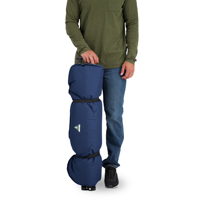 A person standing next to a rolled up Woods Mammoth Folding Padded Camping Chair in Navy