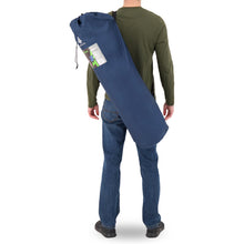Load image into Gallery viewer, Behind view of a person carrying the Woods Mammoth Folding Padded Camping Chair in Navy inside a carry bag across their back