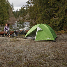 Load image into Gallery viewer, Fully built Woods Cascade Lightweight 2-Person 3-Season Tent next to a woman and two camping chairs on campground