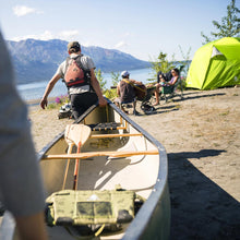 Load image into Gallery viewer, Fully built Woods Lookout Lightweight 4-Person 3-Season Tent with rainfly on campground in the distance
