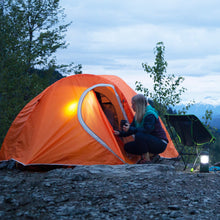Load image into Gallery viewer, A person entering a fully built Woods Pinnacle Lightweight 4-Person 4-Season Tent on campground
