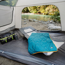 Load image into Gallery viewer, A blanket on top of the Woods Portable Quick Set-Up Adjustable 2-in-1 Camping Cot in Gray next to a duffel bag inside a tent on campground