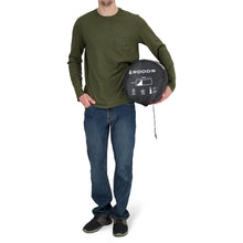 Load image into Gallery viewer, A person carrying the Woods Heritage Cotton Flannel Sleeping Bag in Brown inside carry bag